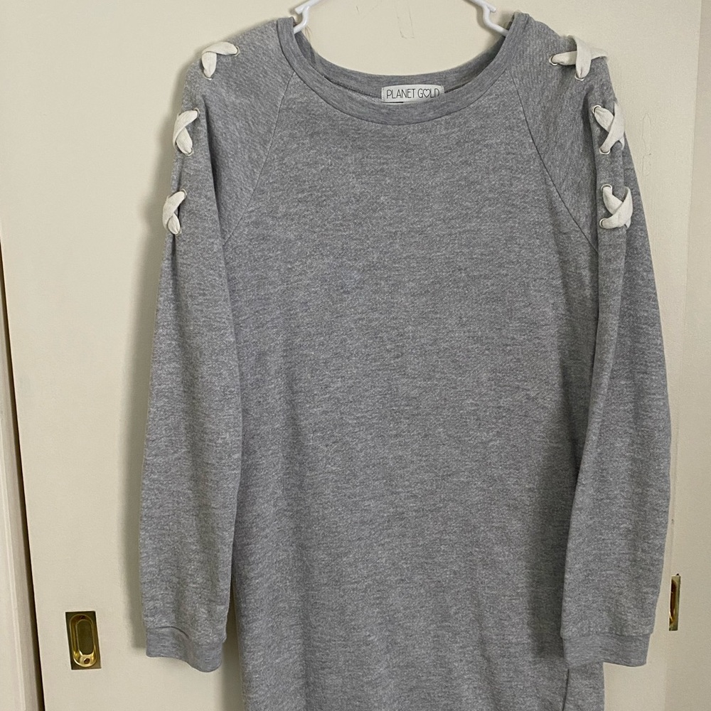 Macy’s sweater dress with cross-stitching on side of the sleeves.